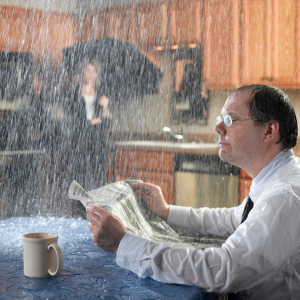water raining down on man reading newspaper in kitchen from hail storm