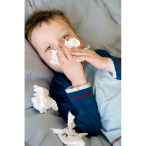 Kid sick on couch with tissues