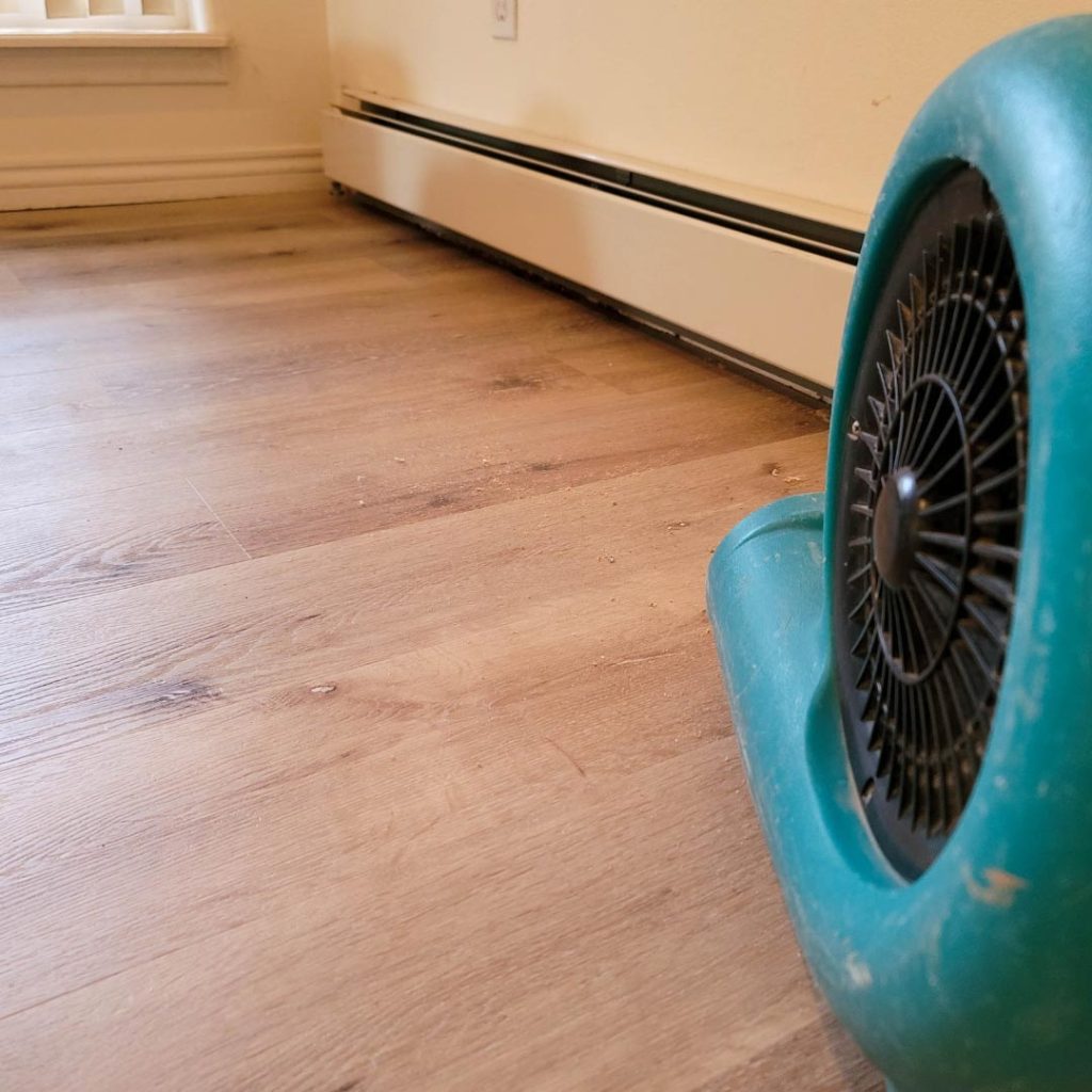 fan drying our floor after water damage in home