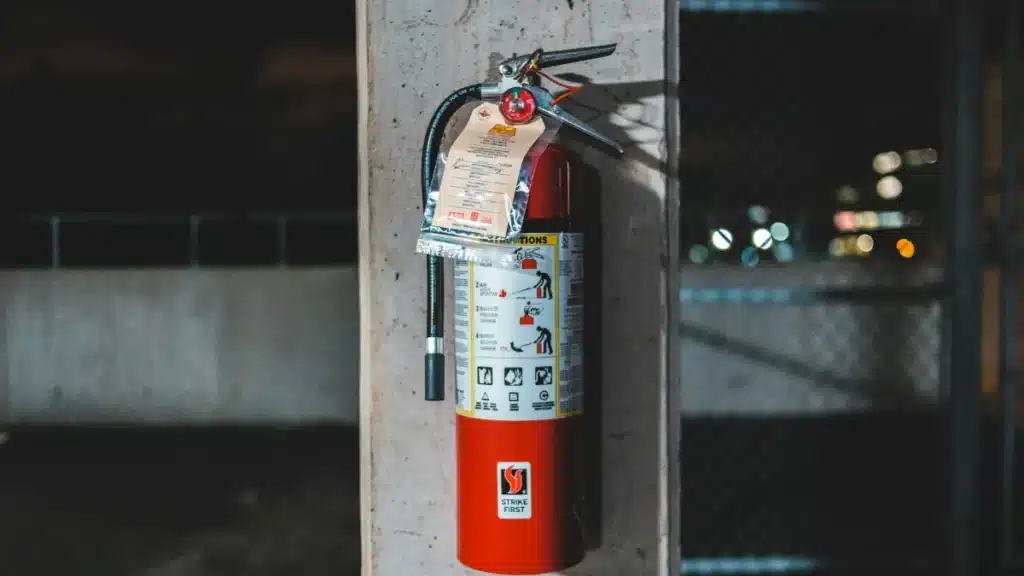 ABC dry chemical fire extinguisher mounted on a concrete column